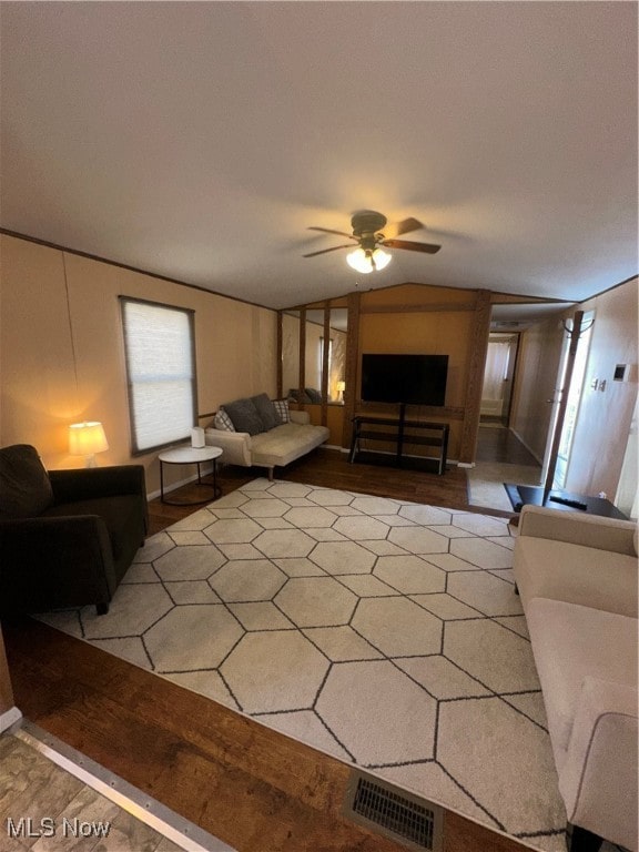 living room with light hardwood / wood-style floors, lofted ceiling, and ceiling fan