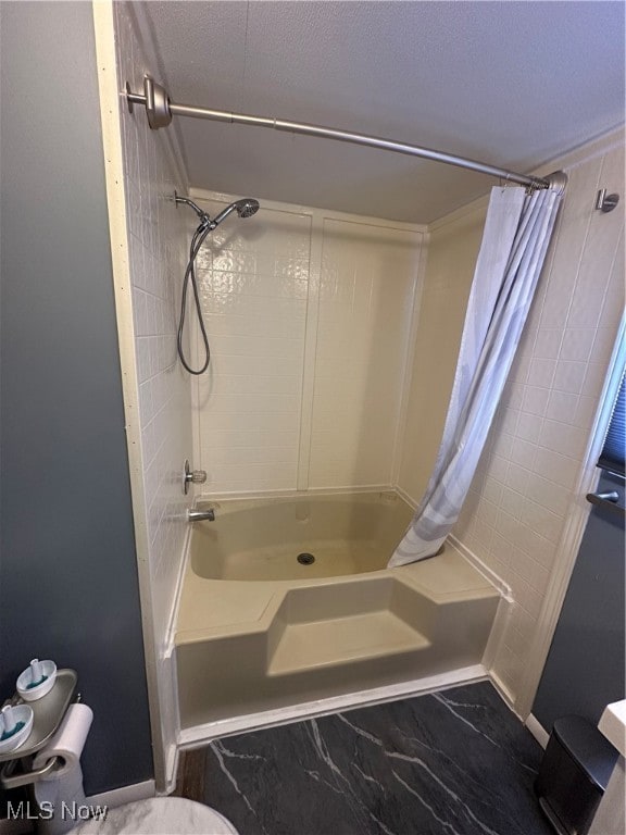 bathroom featuring shower / bath combo with shower curtain and toilet