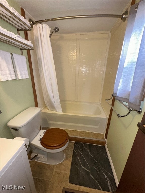 full bathroom with toilet, shower / bath combo, vanity, and tile patterned floors