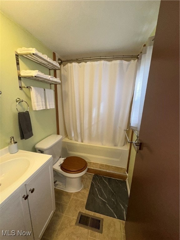 full bathroom featuring tile patterned flooring, vanity, toilet, and shower / bathtub combination with curtain