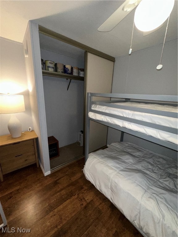 bedroom featuring a closet, ceiling fan, and dark hardwood / wood-style floors