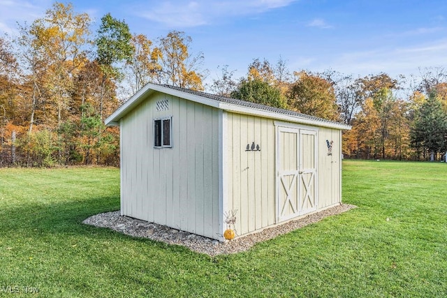 view of outbuilding with a lawn