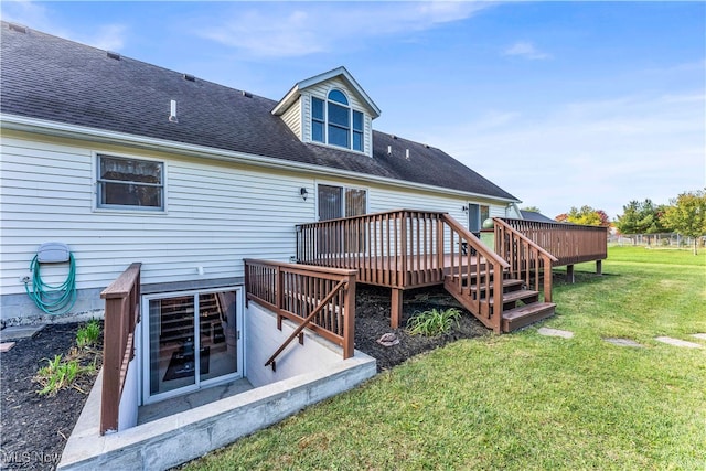 rear view of house featuring a yard and a deck