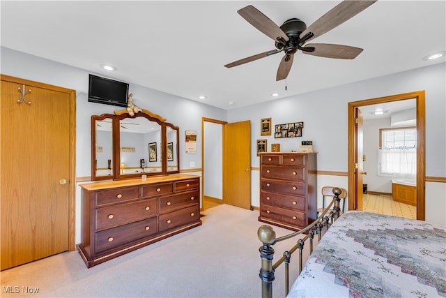 carpeted bedroom featuring ceiling fan and a closet