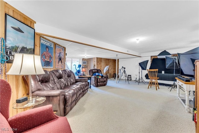 carpeted living room with wooden walls