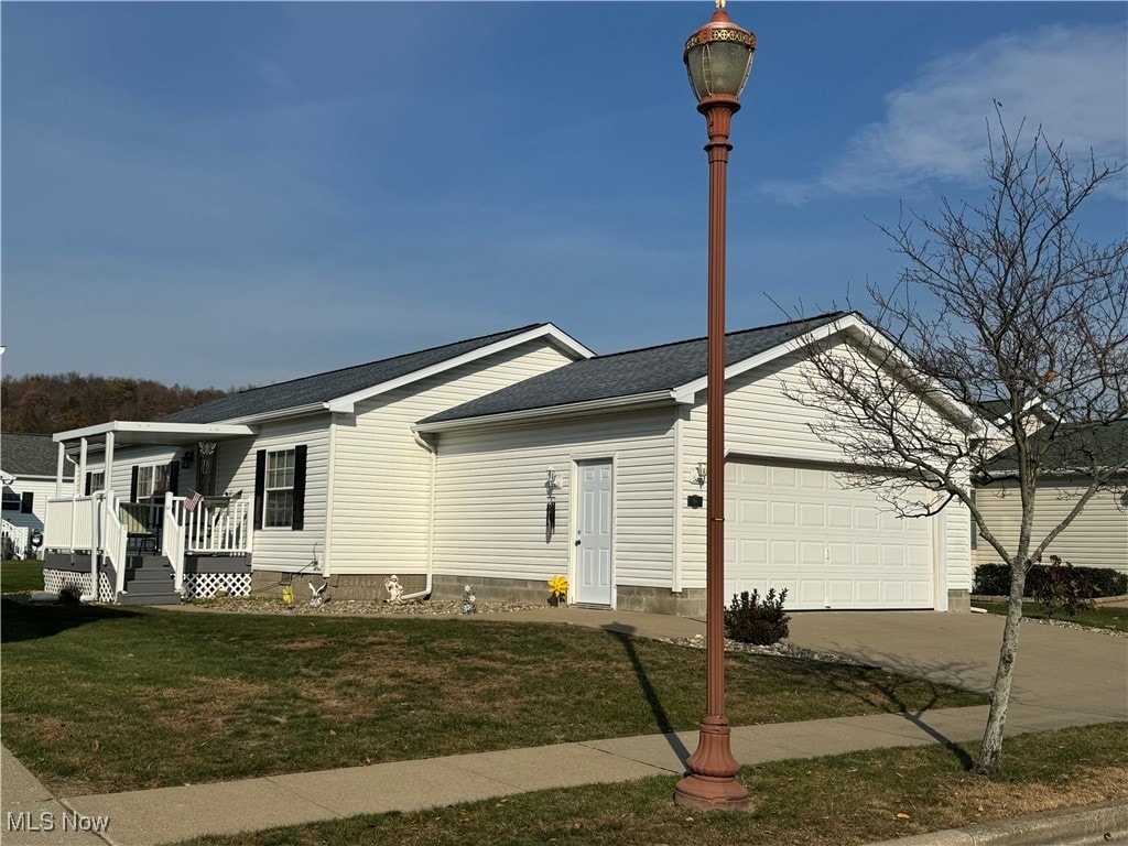 view of front of house with a front yard and a garage