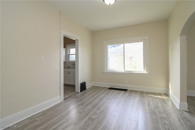 spare room featuring light hardwood / wood-style floors and sink