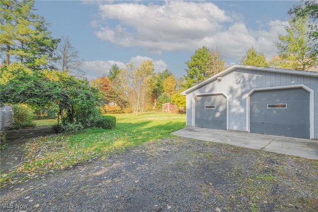 garage featuring a lawn