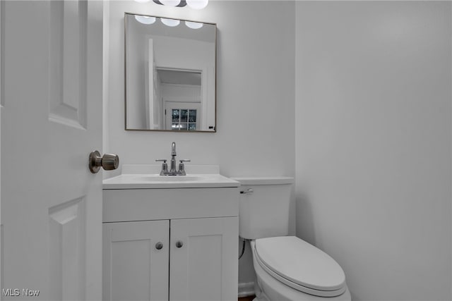 bathroom featuring toilet and vanity