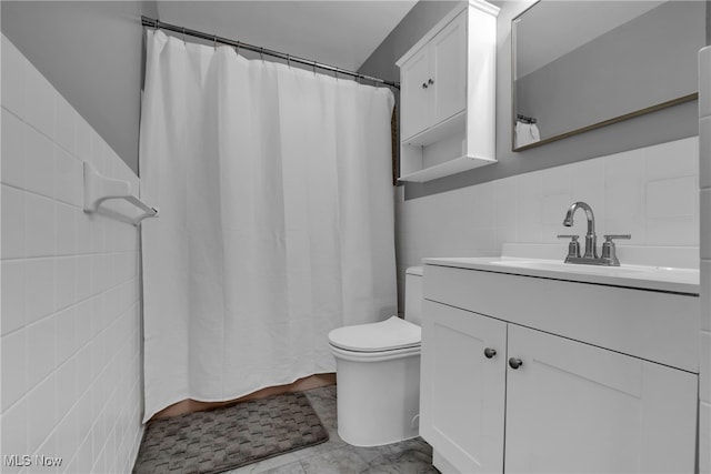 bathroom featuring vanity, a shower with curtain, toilet, and tile walls