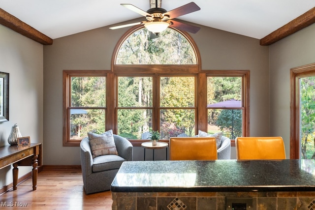 living room with light wood-type flooring, vaulted ceiling with beams, and ceiling fan