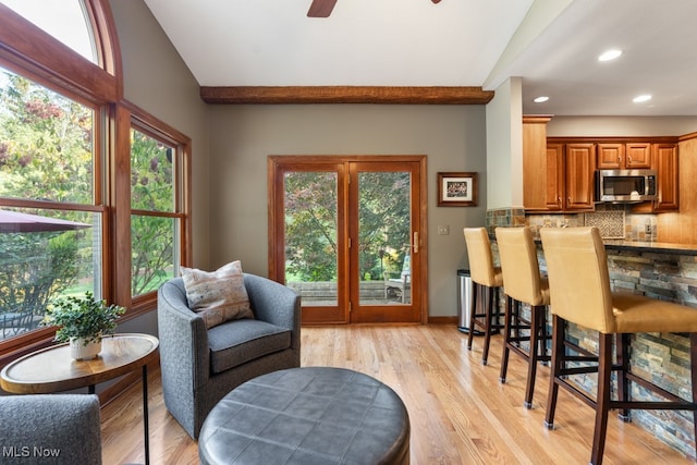 interior space featuring light hardwood / wood-style floors, plenty of natural light, lofted ceiling, and ceiling fan