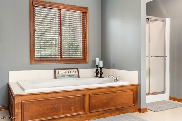 bathroom with tile patterned floors and independent shower and bath