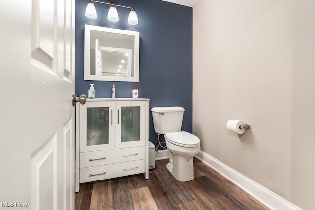 bathroom featuring toilet, wood-type flooring, and sink