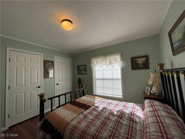 bedroom featuring dark wood-type flooring and a textured ceiling