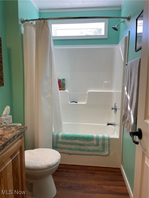 full bathroom featuring vanity, hardwood / wood-style floors, shower / tub combo with curtain, and toilet