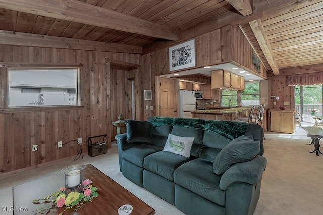 living room with light carpet, wood ceiling, and wooden walls