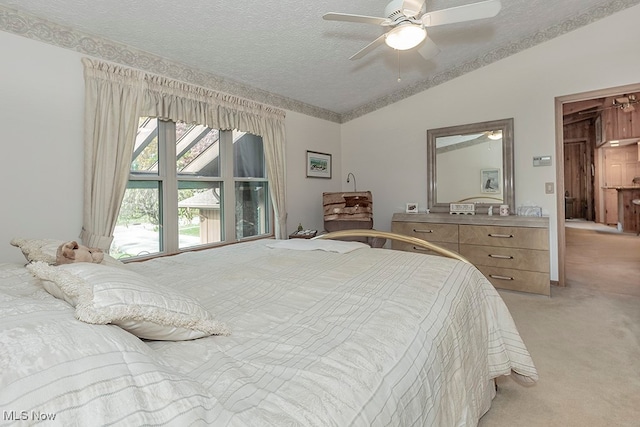 carpeted bedroom with vaulted ceiling, a textured ceiling, and ceiling fan