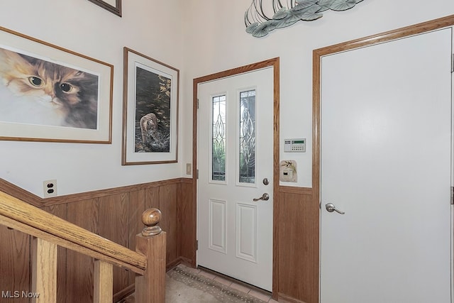 entryway featuring wood walls