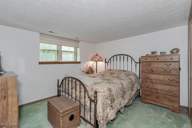 bedroom featuring carpet flooring and a textured ceiling