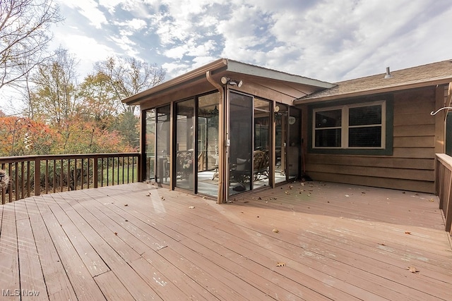 wooden deck with a sunroom