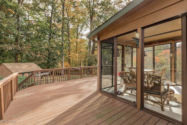 wooden deck with a sunroom