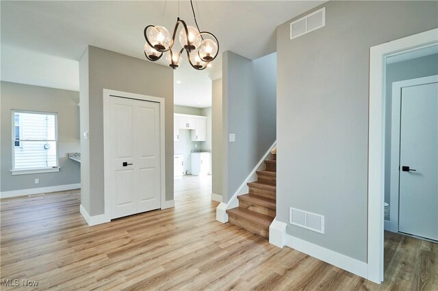V/L E 344th St, Eastlake, OH 44095 - entrance foyer with light wood-style flooring, stairs, baseboards, and a chandelier