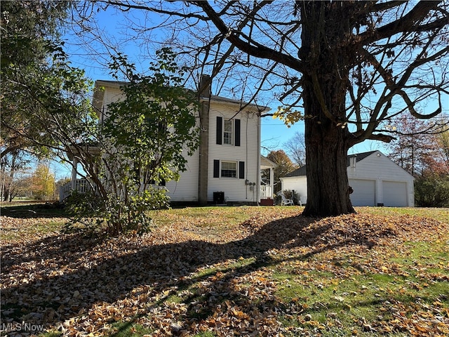 view of home's exterior with an outdoor structure and a garage