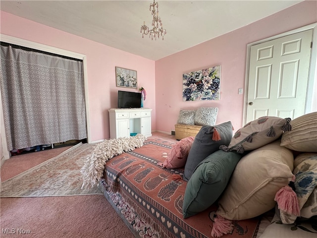 carpeted bedroom with an inviting chandelier