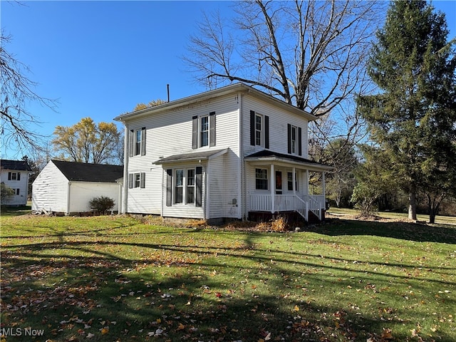 rear view of property with a yard and a porch