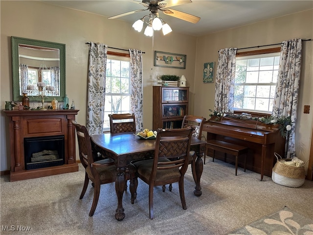 dining space featuring light colored carpet and ceiling fan