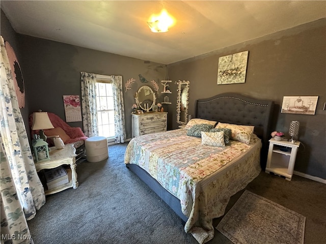 bedroom featuring dark carpet