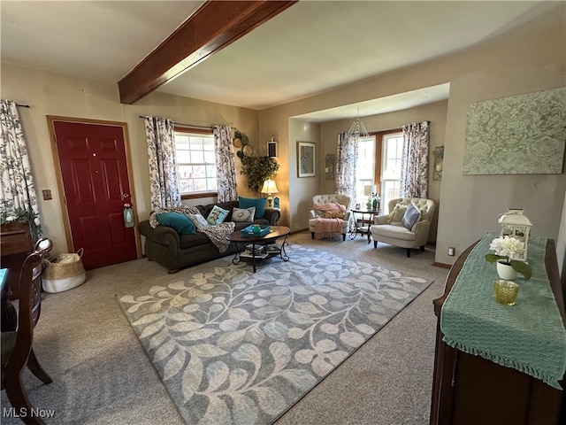 living room with beamed ceiling, carpet floors, and an inviting chandelier