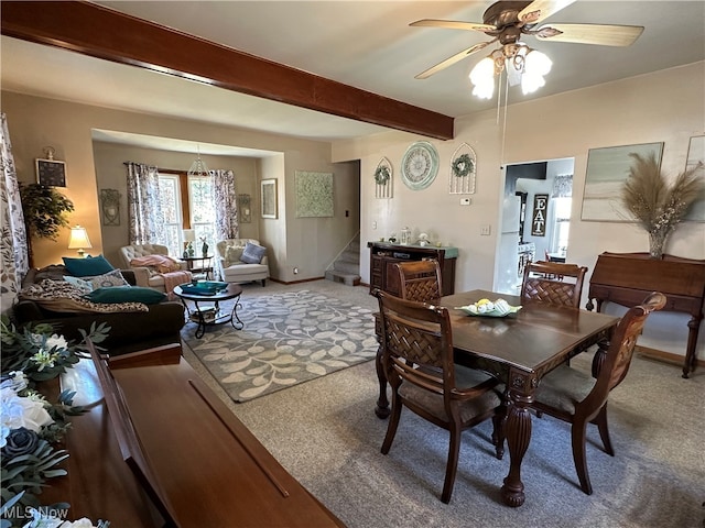 carpeted dining room featuring beam ceiling and ceiling fan