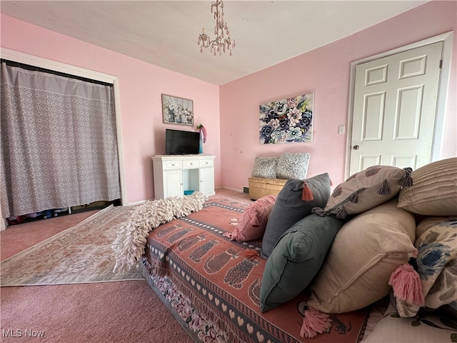 bedroom with carpet and an inviting chandelier