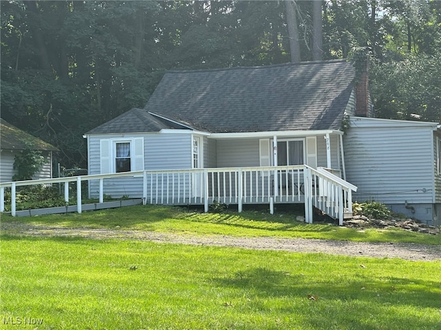 back of property with a lawn