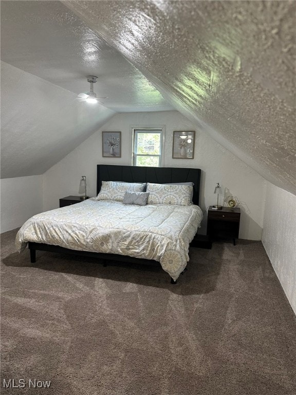 bedroom with lofted ceiling, a textured ceiling, carpet, and ceiling fan