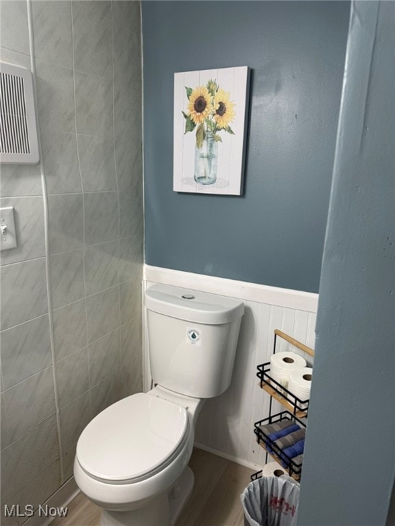 bathroom featuring wood-type flooring and toilet