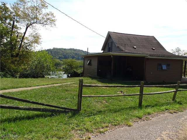 view of side of property with a yard