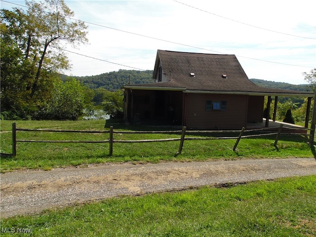 view of side of property with a yard