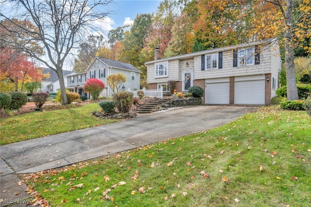 bi-level home with a front yard and a garage