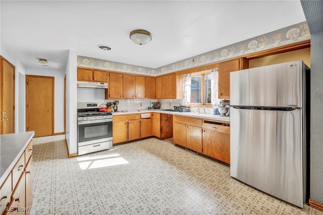 kitchen featuring appliances with stainless steel finishes and tasteful backsplash