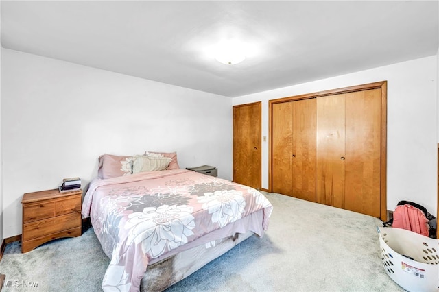 bedroom featuring a closet and light carpet