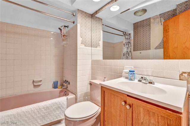 full bathroom with tasteful backsplash, toilet, tile walls, vanity, and shower / tub combo with curtain