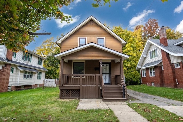 bungalow with a front lawn and a porch