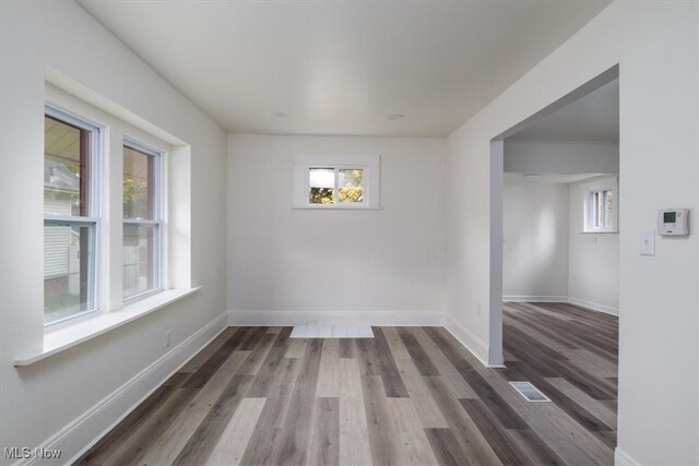 unfurnished room with dark hardwood / wood-style flooring