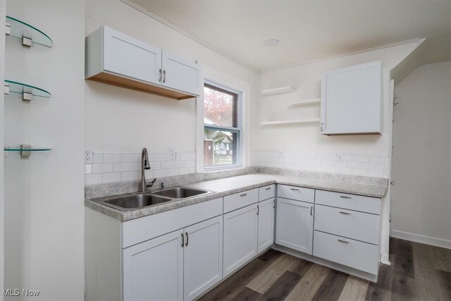 kitchen featuring sink, white cabinets, dark hardwood / wood-style floors, and tasteful backsplash