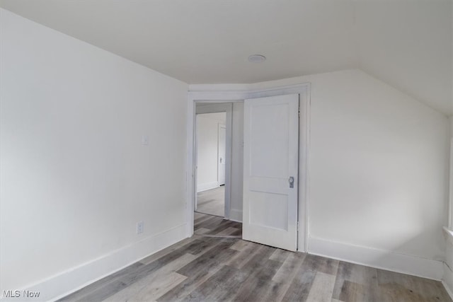 additional living space with lofted ceiling and light hardwood / wood-style flooring