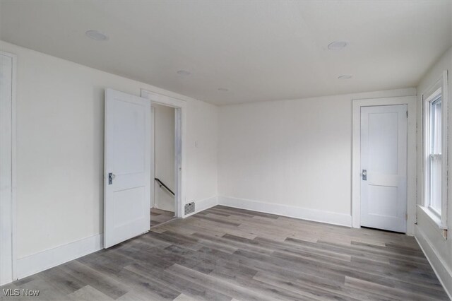 spare room featuring plenty of natural light and light wood-type flooring