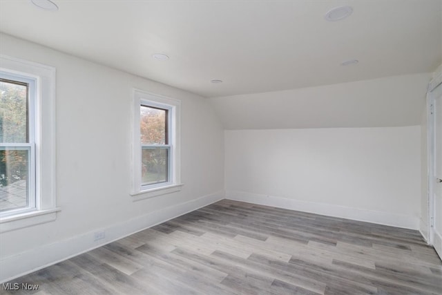 bonus room featuring vaulted ceiling and light hardwood / wood-style flooring